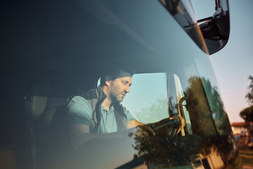 Fototapeta na wymiar Mid adult driver behind the steering wheel of a truck.