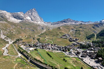 Naklejka premium Panoramic view from above the village of Breuil-Cervinia with the Matterhorn in the background. Breuil-Cervinia, Italy - August 2022