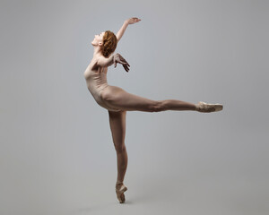 Fototapeta na wymiar charming ballerina posing in the studio on a white background