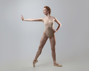 Fototapeta premium charming ballerina posing in the studio on a white background