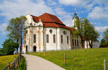 The Pilgrimage Church of Wies (German: Wieskirche) is an oval rococo church in the Bavarian Alps on a sunny day in May (Steingaden, Weilheim-Schongau district, Bavaria, Germany)