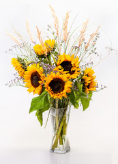 Bouquet of sunflowers in a glass vase on a white background