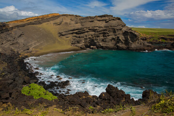 Stunning view of Green Sand Beach - in a bay cut into the side of an ancient cinder cone - on the Big Island of Hawaii.
