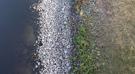 Due to very low water, the river Rhine shows the white turned stones which are normally mostly underwater