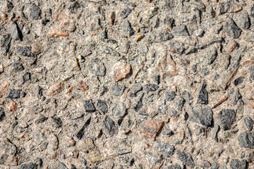 Stone gray background. Gravel in the sun.