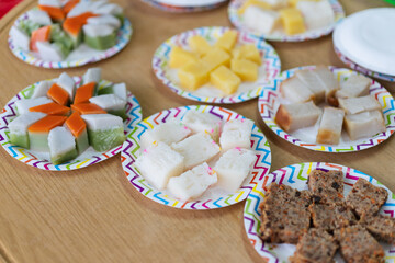 Various Nyonya Kuih decorated display on the paper plates