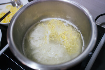 Close up o the boiling water noodle cooking in the pot