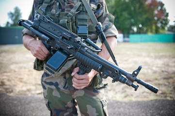 AIR BASE 118 MONT-DE-MARSAN IN FRANCE. September 15, 2011. A French special forces soldier carries a machine gun during training at Air Force Base. Mont-de-Marsan, Landes department, France.