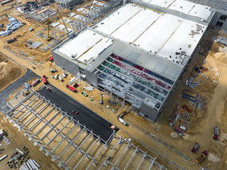 Construction Site. Aerial Photo of Busy Industrial Plant under Construction. Factory Building. Construction Site with Cranes and Heavy Equipment.