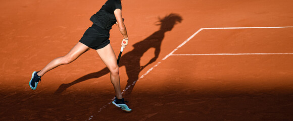 Illustration picture shows the lower body of a young female (woman, lady) professional tennis player competing in a tournament with her racquet after a serve, playing on a clay court