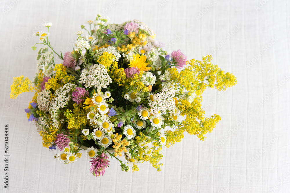 Canvas Prints Summer blooming delicate flowers in a round vase on a table with a white tablecloth, a pastel bouquet and a delicate floral card