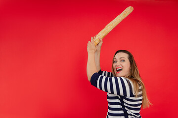 Shouting long haired woman in striped shirt use baguette as sword, cut and breaking discount in red...