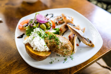 Boiled potatoes with cottage cheese and pickled herring. Defocused