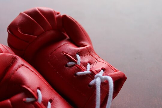 Close up image of red boxing gloves on table. Sports concept