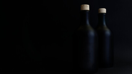 Gin bottles, dark shot of two black gin bottles with natural corks. Copy space for your design. Web...