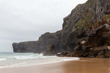 beach in the north of spain with a rough sea and beautiful cliffs