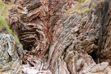 rocks with faults and winding sediments, on a beach in northern Spain, in asturias,