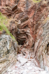 rocks with faults and winding sediments, on a beach in northern Spain, in asturias,