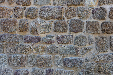 Roman defensive stone wall texture with irregular polygonal blocks built in ancient times. Background with copy space