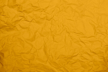 Closeup yellow crumpled paper texture background. Yellow wrinkled paper texture background. Yellow crease fabric texture background. Yellow wrinkled fabric texture background.