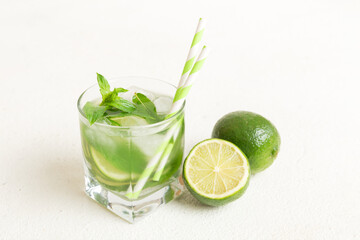 Mojito cocktail. Refreshing mojito cocktail with lime, lemon and mint in a tall glass with a stick