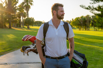 Golf is a style of living. Cropped image of male golfer carrying golf bag with drivers while...