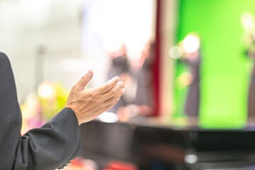 Singing together, raising hands to worship Jesus in the church