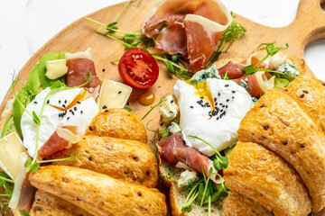 Variety of aperitifs Croissant sandwiches with jamon ham serrano paleta iberica, blue cheese,...