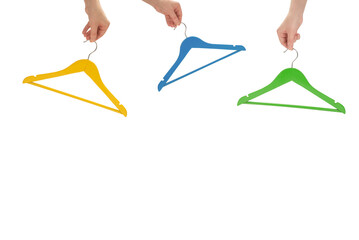 Yellow hanger in woman hand isolated on white.