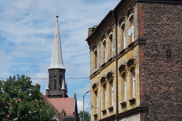 Fototapeta na wymiar Steeple of John the Baptist Church (Kosciol im. Jana Chrzciciela) (evangelical, neo-gothic style) in the background. Swietochlowice, Poland.