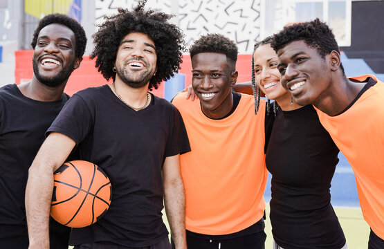 Multiethnic people hugging each other after basketball match outdoor
