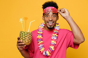 Shocked young fun man he wear pink t-shirt hawaiian lei near hotel pool drink straw pineapple juice...