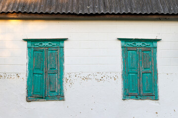 Fototapeta na wymiar old wooden windows with closed shutters