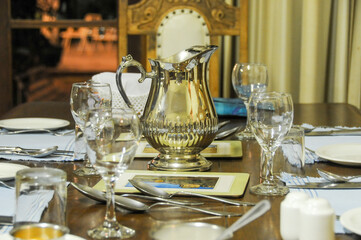 Homestyle table setting with glasses and water jug, close-up of a portion of the table