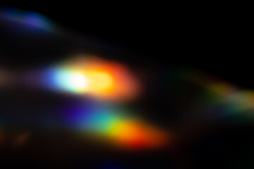 Blur colorful rainbow crystal light leaks on black background. Defocused abstract multicolored retro film lens flare bokeh analog photo overlay or screen filter effect. Glow Vintage prism colors