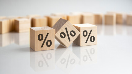 close up image a wooden cube with percent signs on wooden cubes. white background