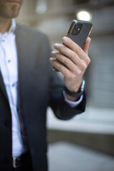 Close up Young Businessman holding and using smartphone, hand holding texting message on screen mobile chatting. business, lifestyle, technology device and Social media network concept