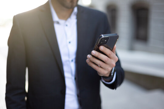 Close up Young Businessman holding and using smartphone, hand holding texting message on screen mobile chatting. business, lifestyle, technology device and Social media network concept