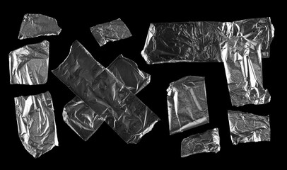 Aluminum foil tape pieces set and collection isolated on black background with clipping path, top view
