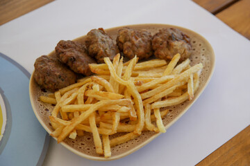 Fried meatballs served with french fries