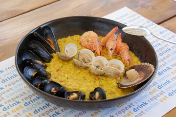 Summer seafood risotto. Various mussels, clams, scallops, shrimps with rice.