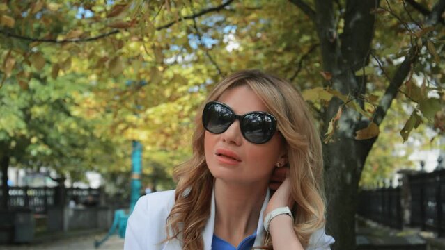 Beautiful business woman in sunglasses portrait in the park