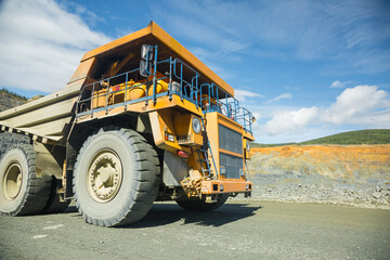 Quarry for iron ore extraction. Mining of copper ore. Transportation of copper ore rocks by dump...