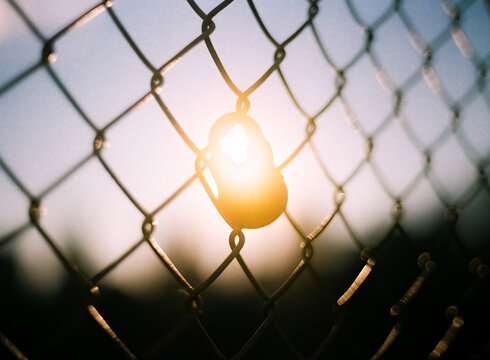 Lock on a fence at sunset