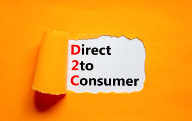 D2C direct to consumer symbol. Concept words D2C direct to consumer on white paper on a beautiful orange background. Business and D2C direct to consumer concept. Copy space.
