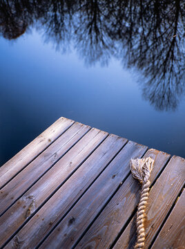 wooden pier on a lake with reflections