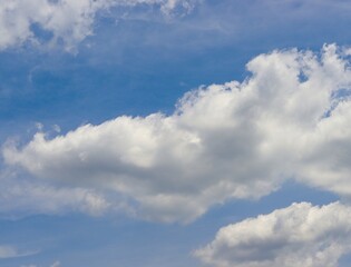 Fototapeta na wymiar The white cloudscape in the summer blue sky.
