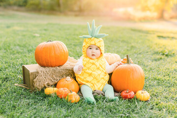 Cute baby boy dressed in halloween pineapple costume