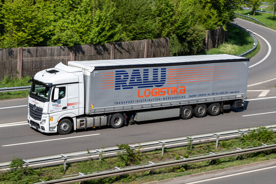 WIEHL, GERMANY - MAY 3, 2022: RALU Logistika Mercedes-Benz Actros truck with curtainside trailer on motorway