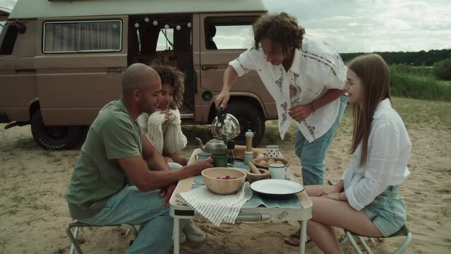 A group of people having a breakfast outdoor 